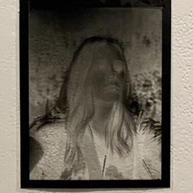 Large format film negative of the student outside, looking to the right.