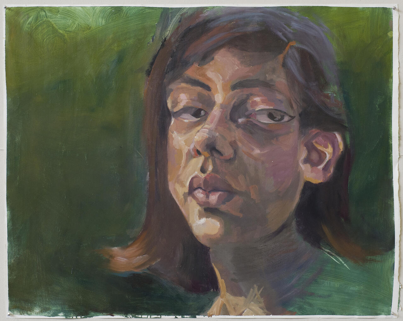 Self portrait of artist with a painted green background.