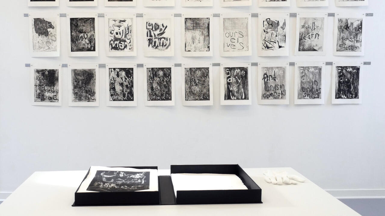 Many different monochromehand mades prints made with different printmaking processes all hung up on a white wall