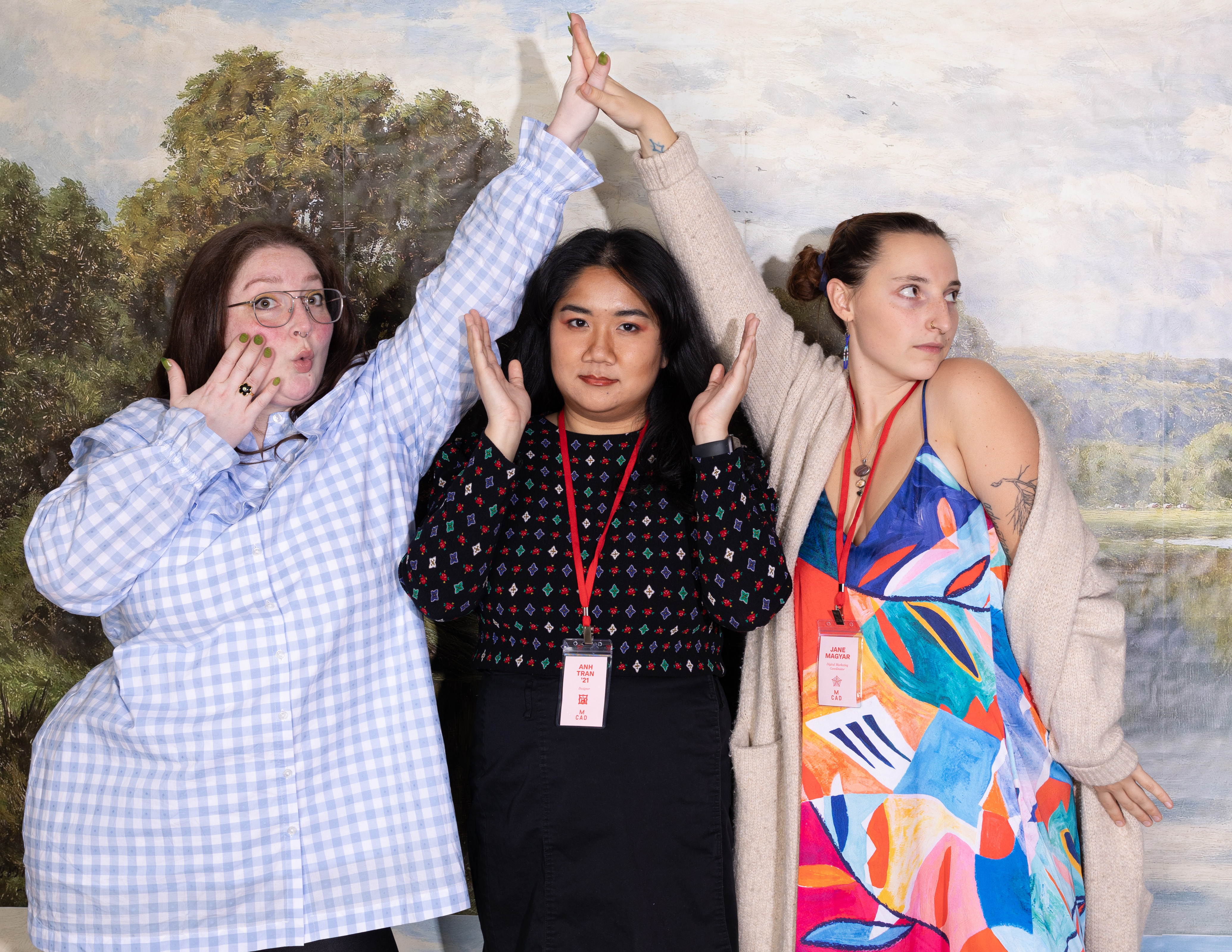 three people standing in front of the 2024 MCAD Art Sale photobooth backdrop