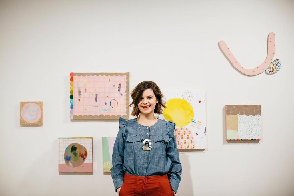 Portrait of Ashely Peifer standing in front of her work.