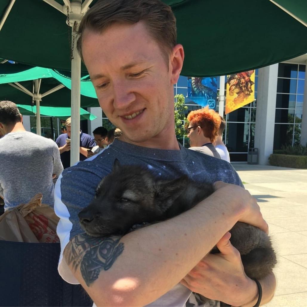 Photograph of Chris Havranek holding a wolf pup.