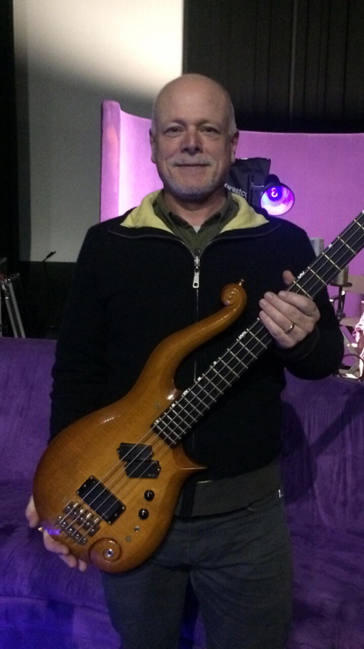 Gerald Ronning holding one of Prince's guitars