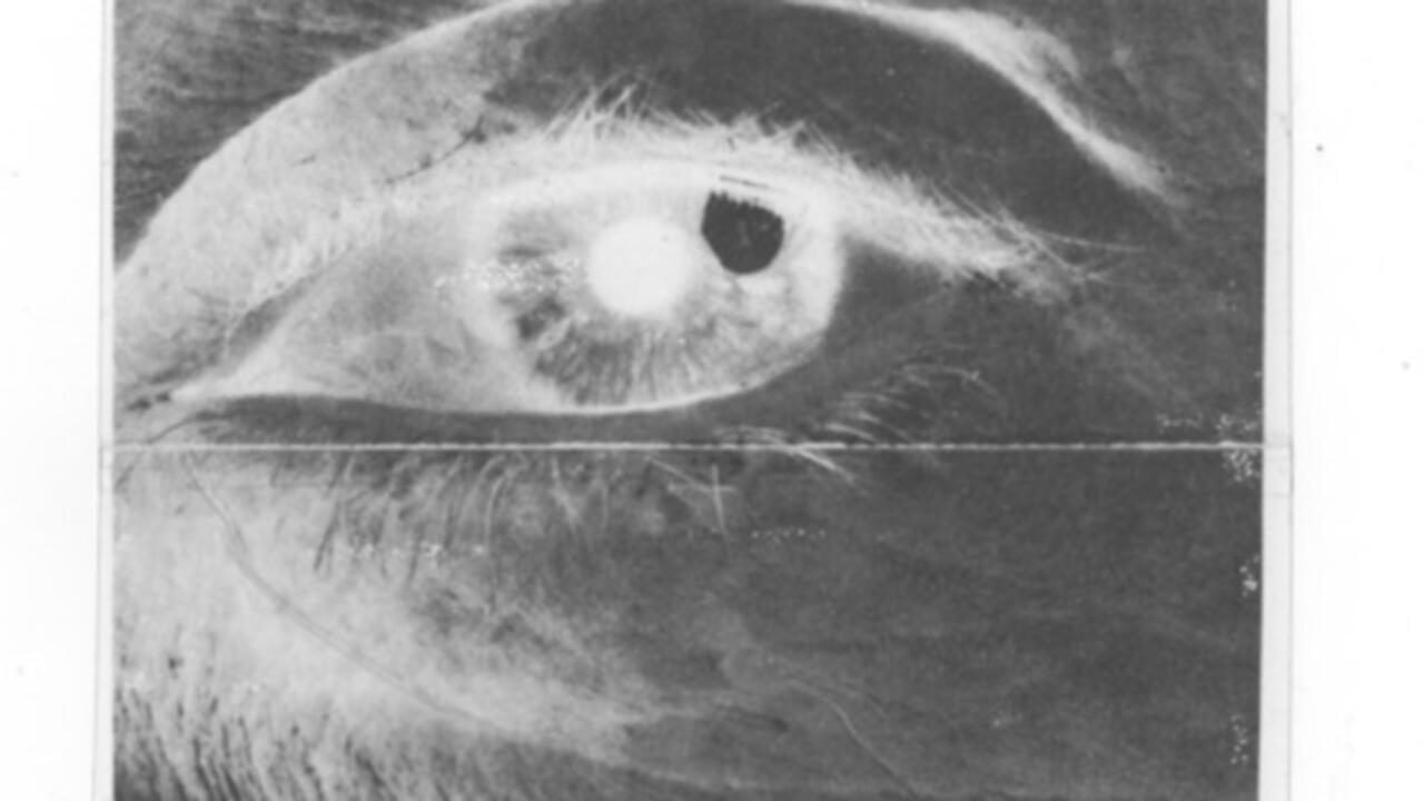 An inverted close up image of an eye looking upwards and to the right