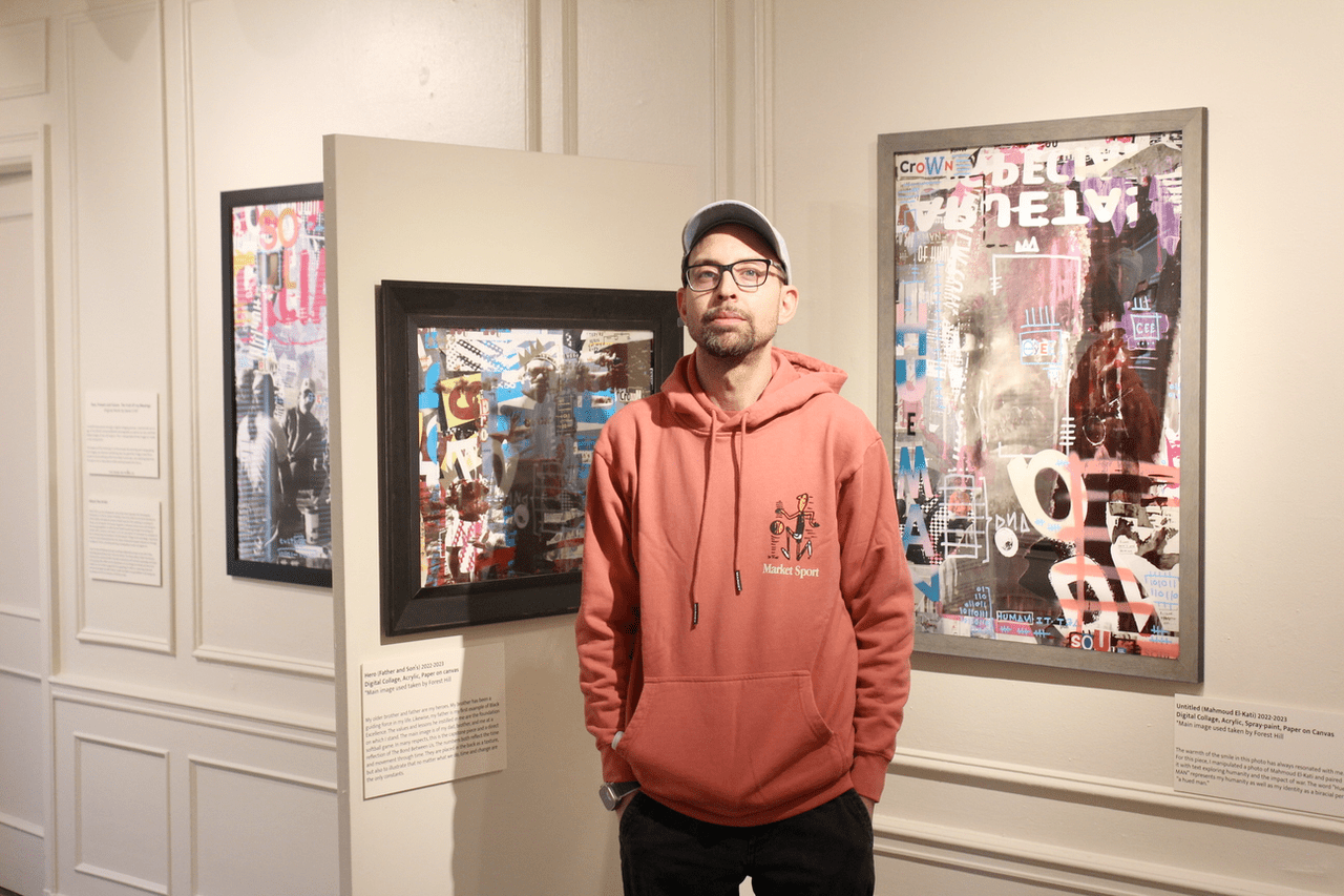 An image of Daren Hill standing by his exhibition, "The Bond Between Us".