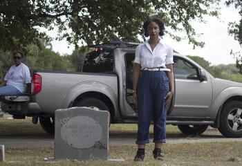 Candice Davis standing by a gravestone