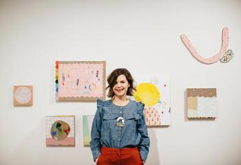 Portrait of Ashely Peifer standing in front of her work.