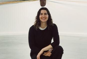 Jennifer O'Connell posing in front of a yarn sculpture 